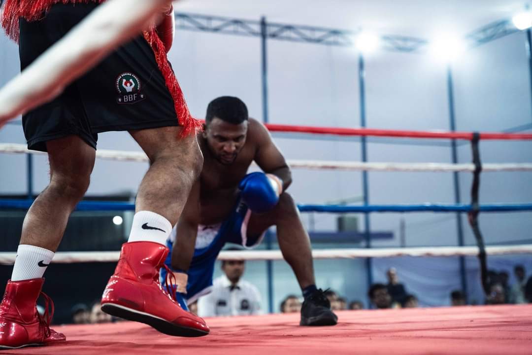 Low angle of a boxer in red boots moving in on his opponent