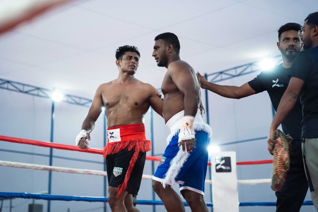 Two boxers in the ring with officials before a bout