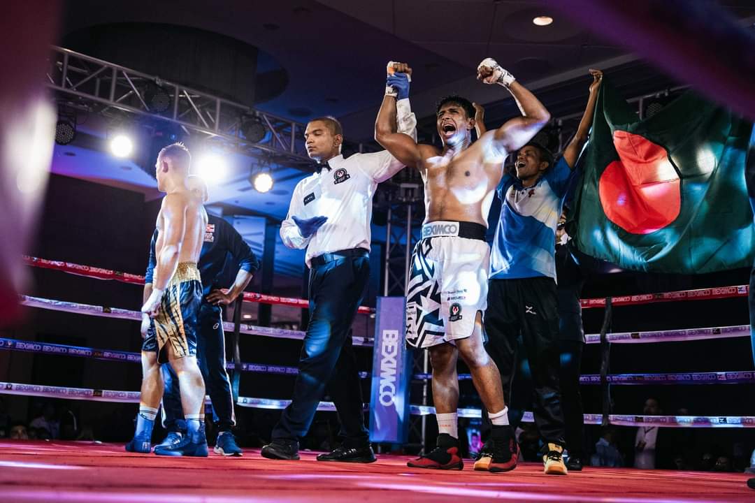 Al-Amin's hand raised, with his corner and the Bangladesh flag