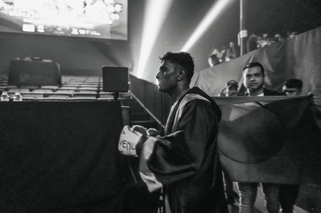 Black-and-white shot of Al-Amin in his robe at ringside