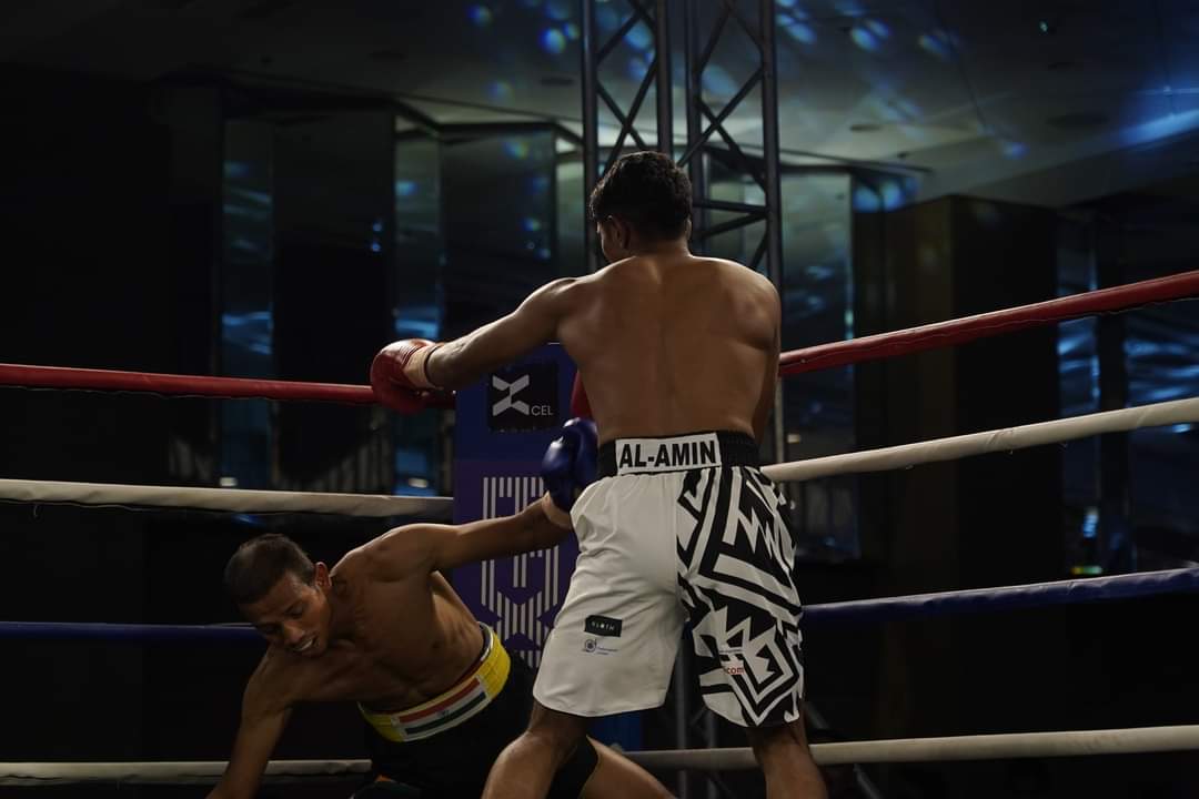Al-Amin standing over an opponent who has gone down
