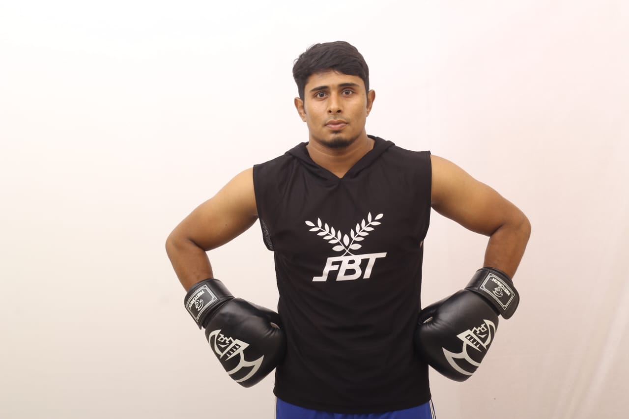 Studio portrait: Al-Amin with his hands on his hips