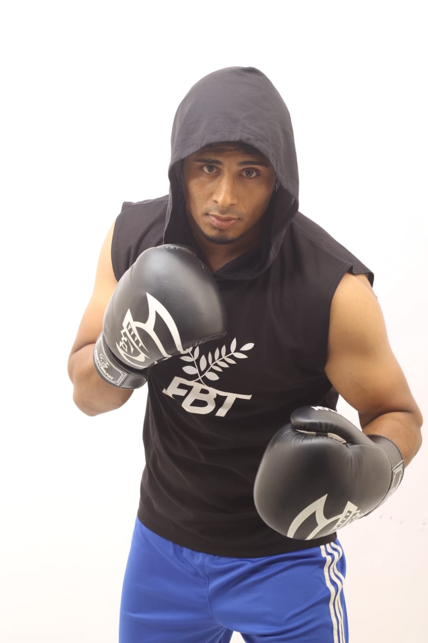 Studio portrait: Al-Amin, hood up, in his stance