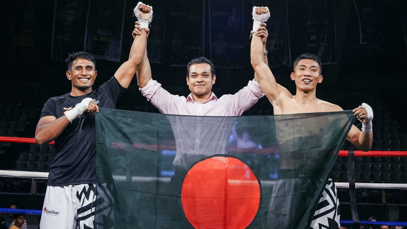 Al-Amin and his opponent holding the Bangladesh flag after the bout