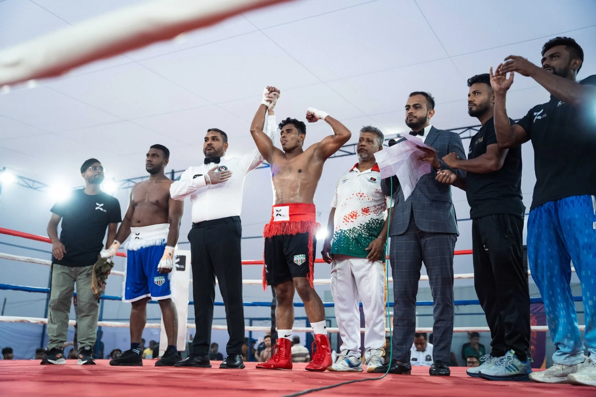 Al-Amin flexing as the referee raises his hand