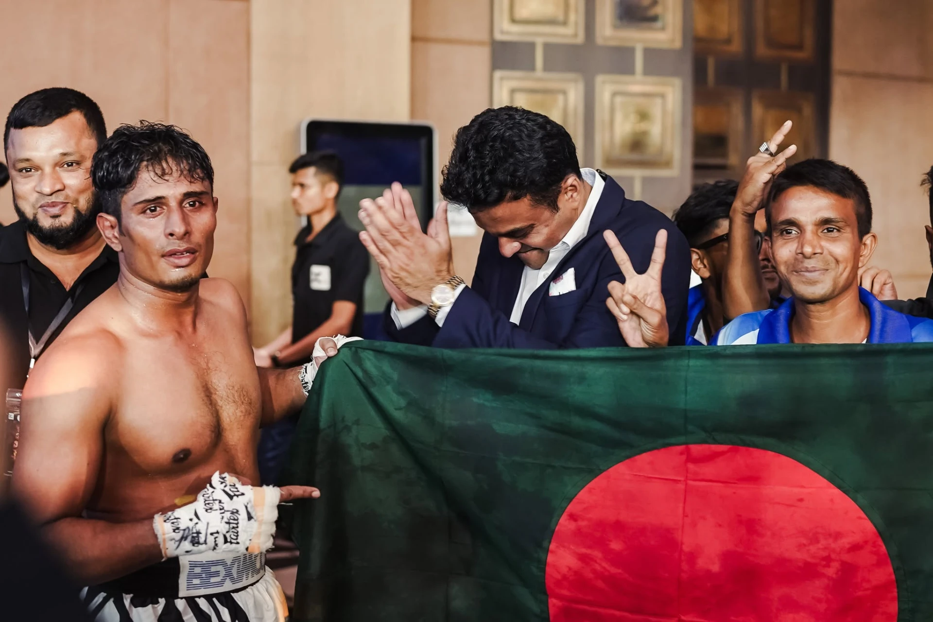 Al-Amin celebrating with supporters and the Bangladesh flag